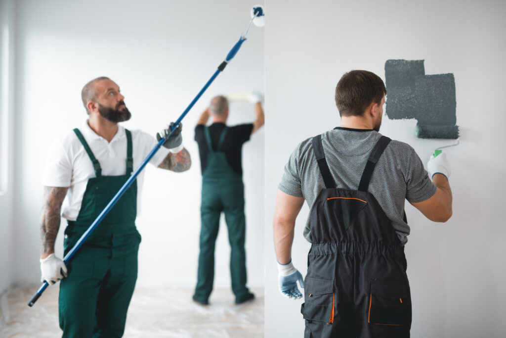 Apartment maintenance staffing agency crew painting interior walls in vacant rental unit