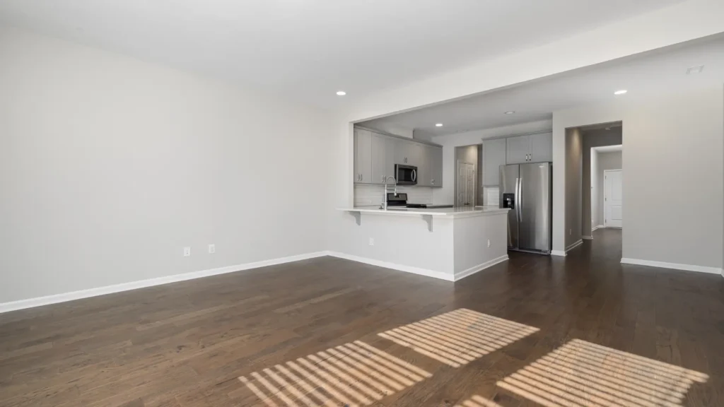Modern apartment interior with open kitchen and hardwood floors