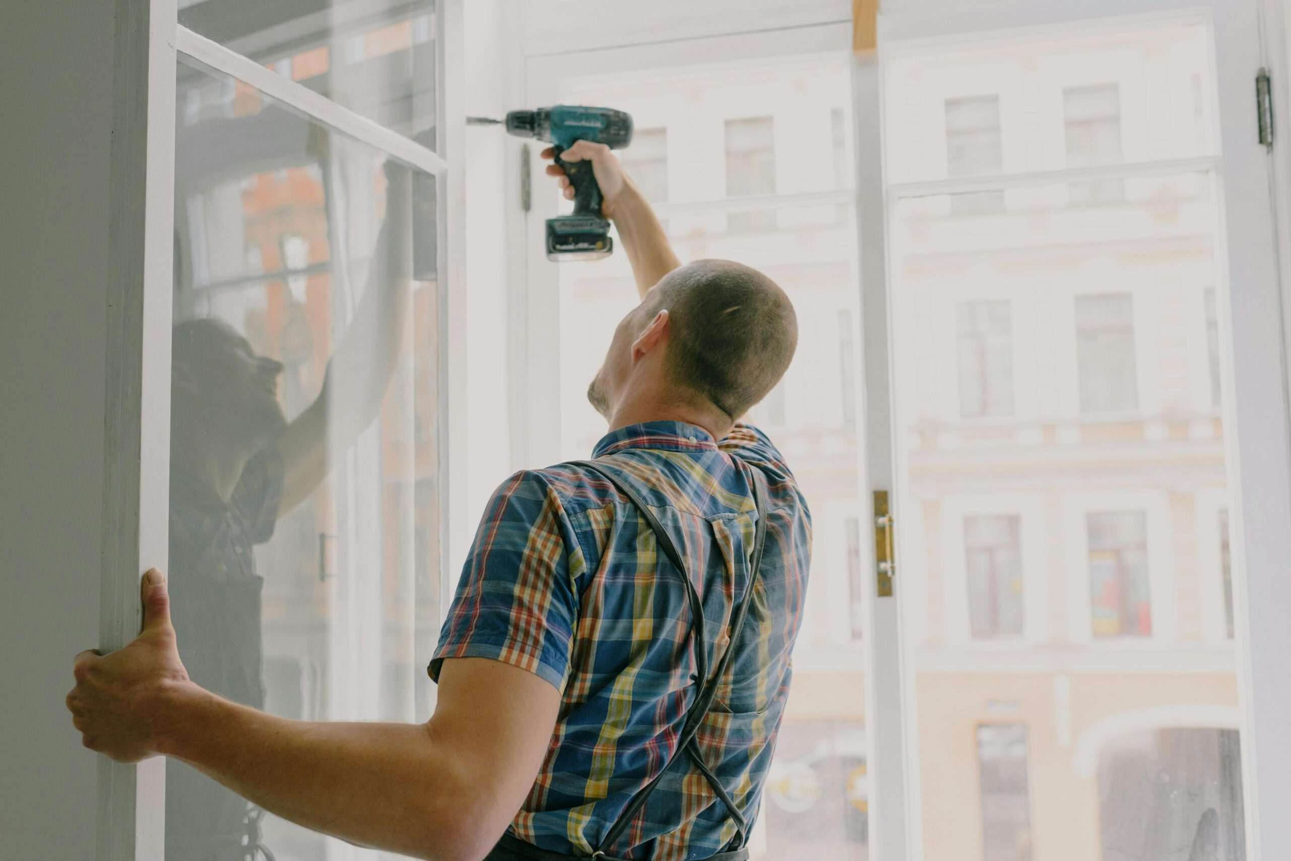 apartment-turnover-services man repairing a window during an apartment turnover